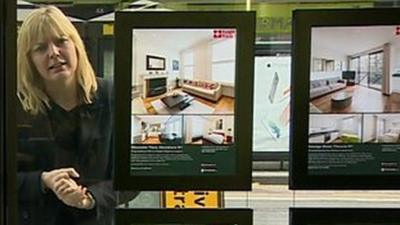 Reporter in estate agent window