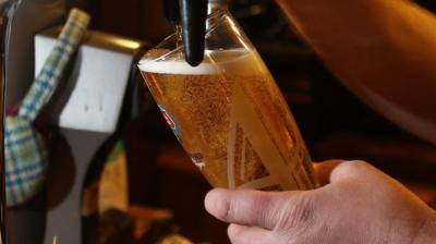 A pint of beer being pulled 