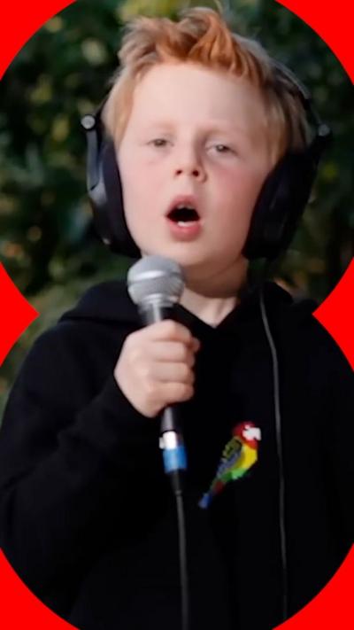 Miles Phillips singing into a microphone