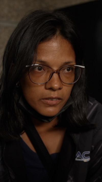 Close-up of woman wearing black jacket and glasses