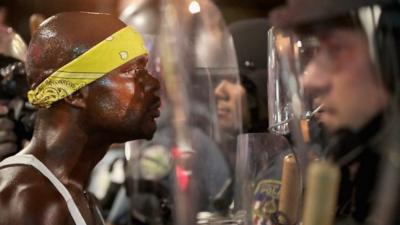 Protester and police officer face-to-face in Missouri.