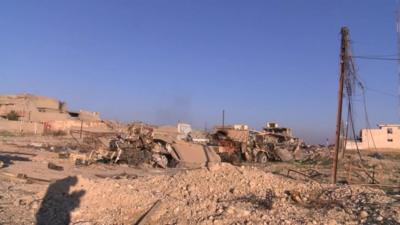 Rubble and damaged buildings and vehicles