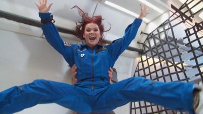 Blue Peter's Lindsey Russell jumping in the air inside a zero gravity aeroplane.