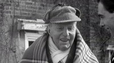 A. E. Matthews in a deerstalker hat.