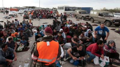 Migrants wait for buses in Nickelsdorf, Austria