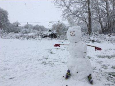 Snowman in the garden with rollerblades