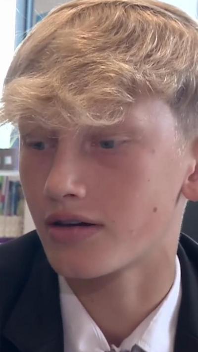 A young boy in school uniform