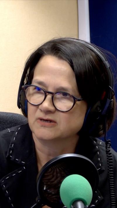 Catherine West sitting in a BBC studio in front of a microphone