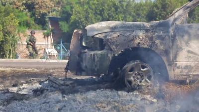 The hood of a truck that was set on fire is still smoking