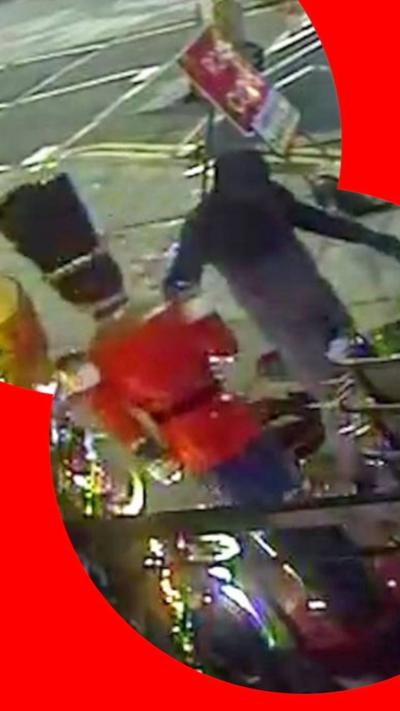 Still from camera footage. Outline of a man in black holding a life size nutcracker 