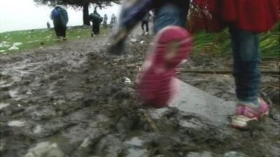 Migrant walking in mud in Macedonia