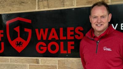 Performance director Gareth Jenkins alongside a Wales Golf sign