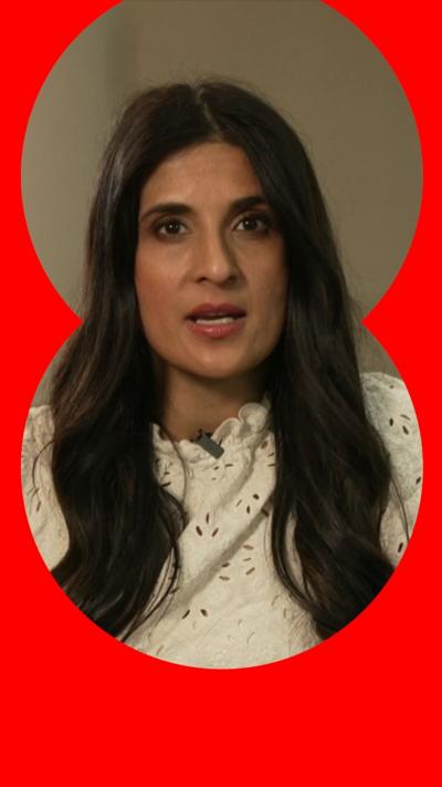 A woman, Nomia Iqbal, with long black hair in a white top