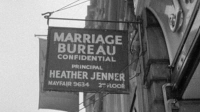 A hanging sign which reads 'Marriage Bureau Confidential'.