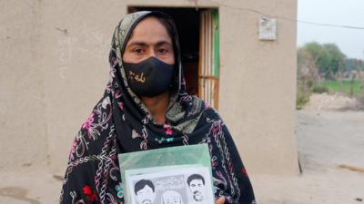 Rehana Magsi holding her campaign flyer