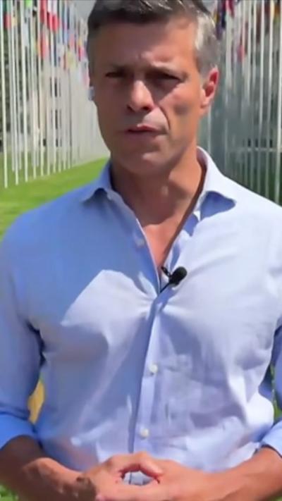Leopoldo Lopez standing as he speaks 
