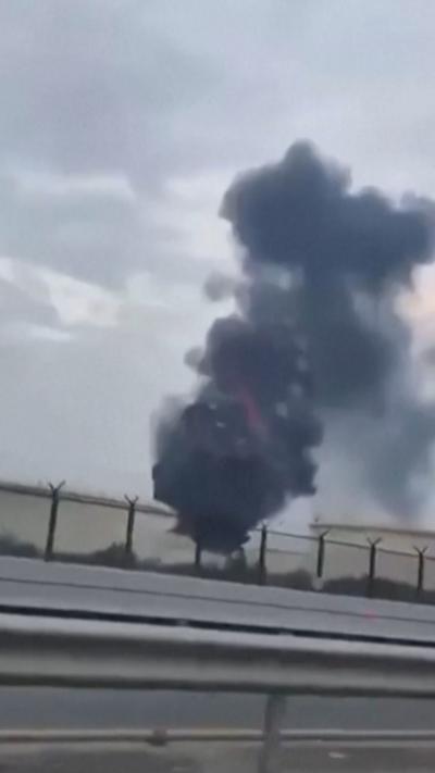 Smoke rising from Bahrain oil facility, seen from a passing car