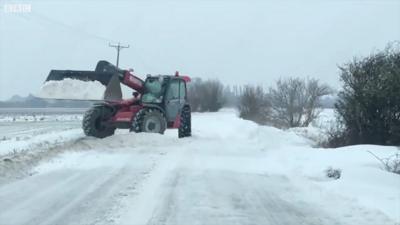 Tractor shoveling snow