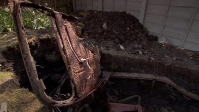 Car buried in garden