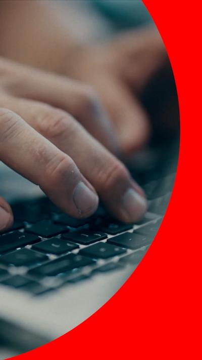 Fingers typing on a laptop keyboard