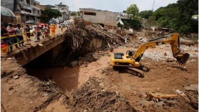 Excavator clearing mudslides in Mocoa, Colombia