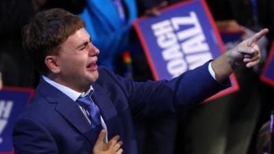 Gus Walz reacts to his father's speech at the DNC