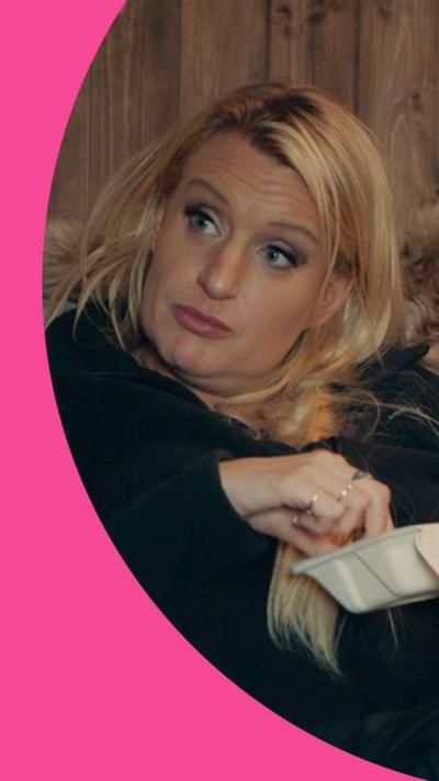 Daisy May Cooper with her hand in a takeaway box