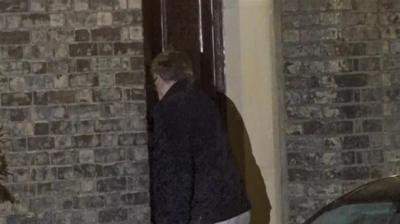 The back of Peter Mandelson as he enters the front door of his house.