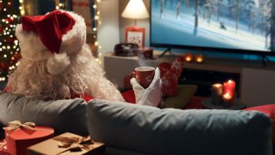 Santa Claus watching TV