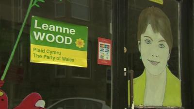 Plaid Cymru election poster and picture of candidate Leanne Wood on shop window