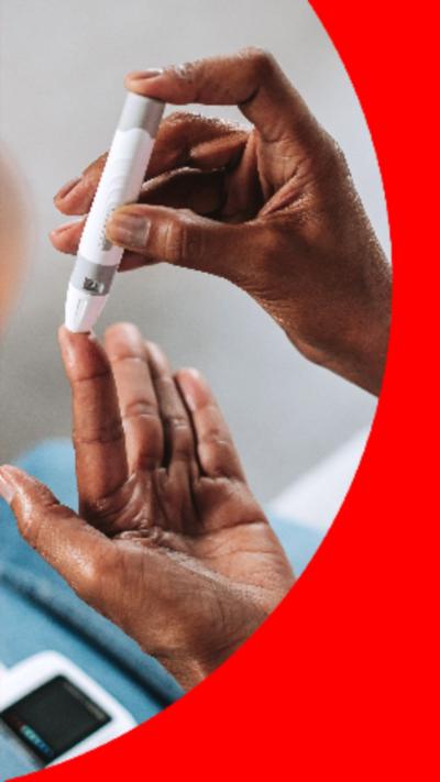 Woman tests uses diabetes pen in the tip of her left index finger