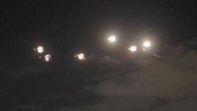 Explosions are seen in the dark sky over Kyiv