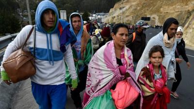 Venezuelans heading to Peru walk along the Panamerican highway in Tulcan, Ecuador