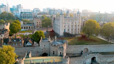 A drone shot of the Tower of London surrounded by ceramic poppies