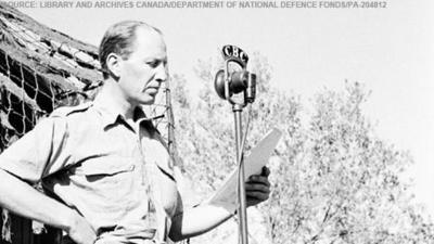 Matthew Halton of the Canadian Broadcasting Corporation next to a CBC microphone.