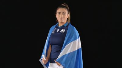 Emma Wassell poses with a Scotland flag wrapped around her