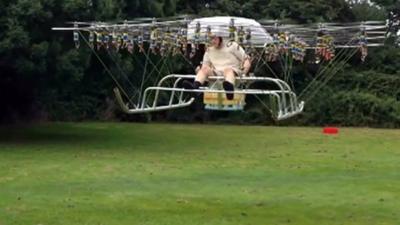 A multi-rotor drone carrying a man