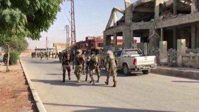 Forces walk through Tel Abyad