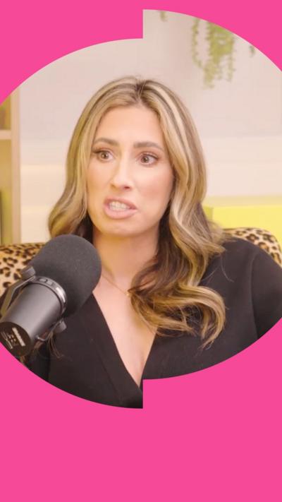 Stacey Soloman sits in-front of a black microphone. 