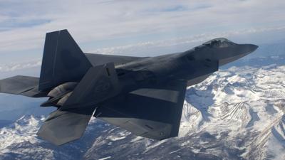 F-22 jet flying over the Sierra Nevada mountains in an archive photo