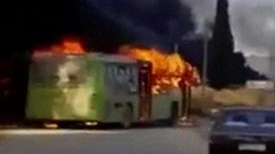 Burning evacuation bus in Syria