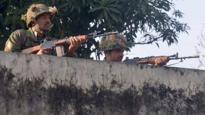 Indian army soldiers take up position on the perimeter of the airforce base in Pathankot on January 3, 2016.