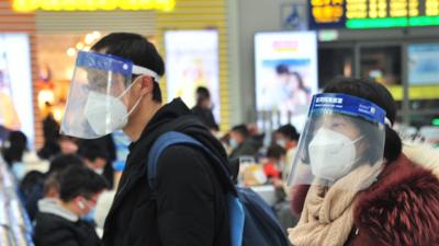 Passengers wearing face masks wait for their trains at Hongqiao Railway Station one day before the Spring Festival travel rush on January 27, 2021 in Shanghai, China