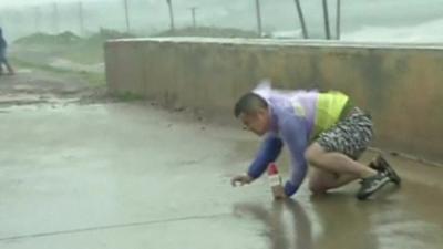 Man trying to get up in the strong wind