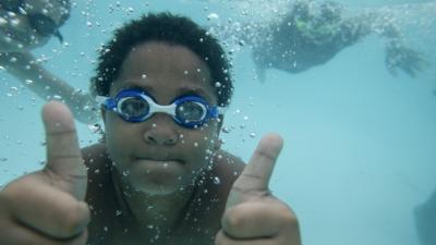 kid swimming with friends