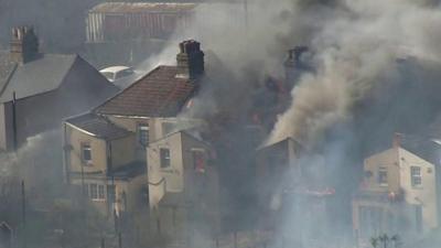 Smoke pouring from a home