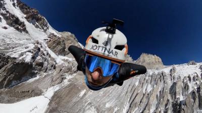 Man flying through the air in goggles