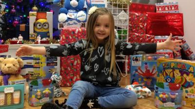 Lily with presents she has collected for hospital patients