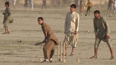 Afghan men playing cricket