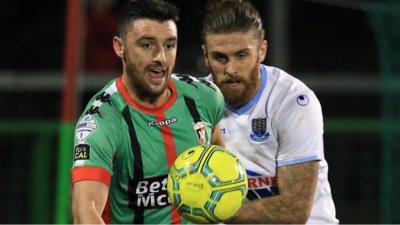 Action from Glentoran's home defeat to Ballymena United